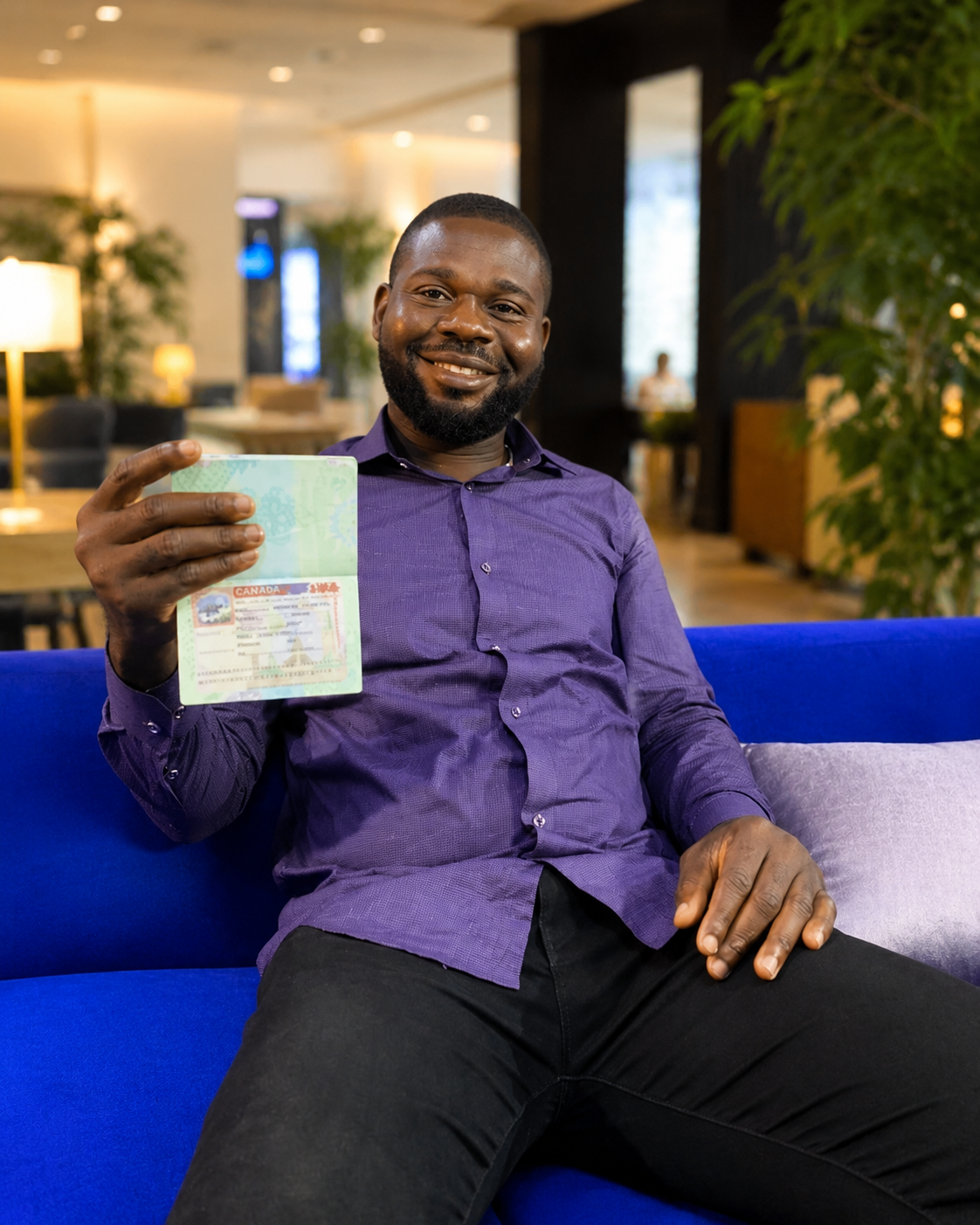 Ifeanyi Chinedu smiling with a passport in hand